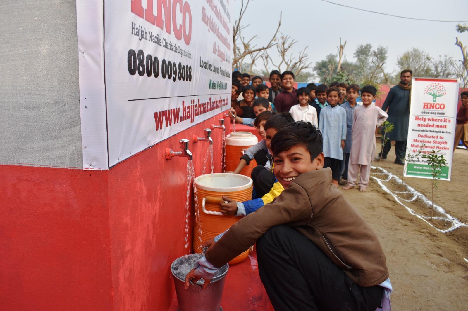 Children collecting clean water from HNCO solar pump taps