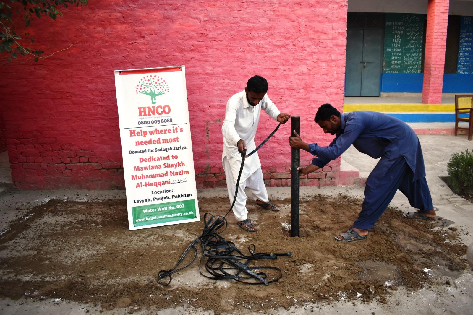 Workers installing pipes for HNCO sadaqah jariyah water well