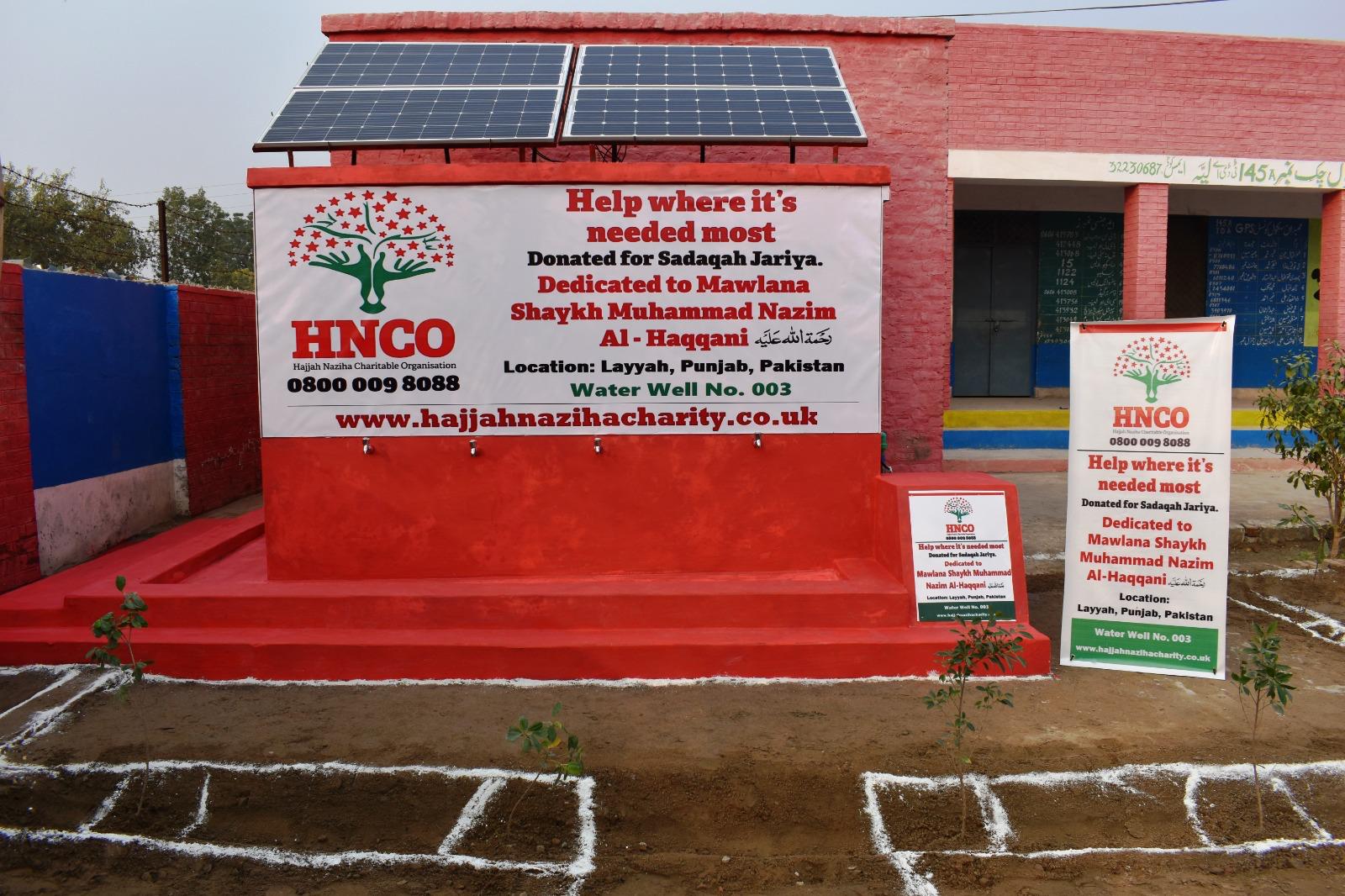 Completed solar water pump station with HNCO branding